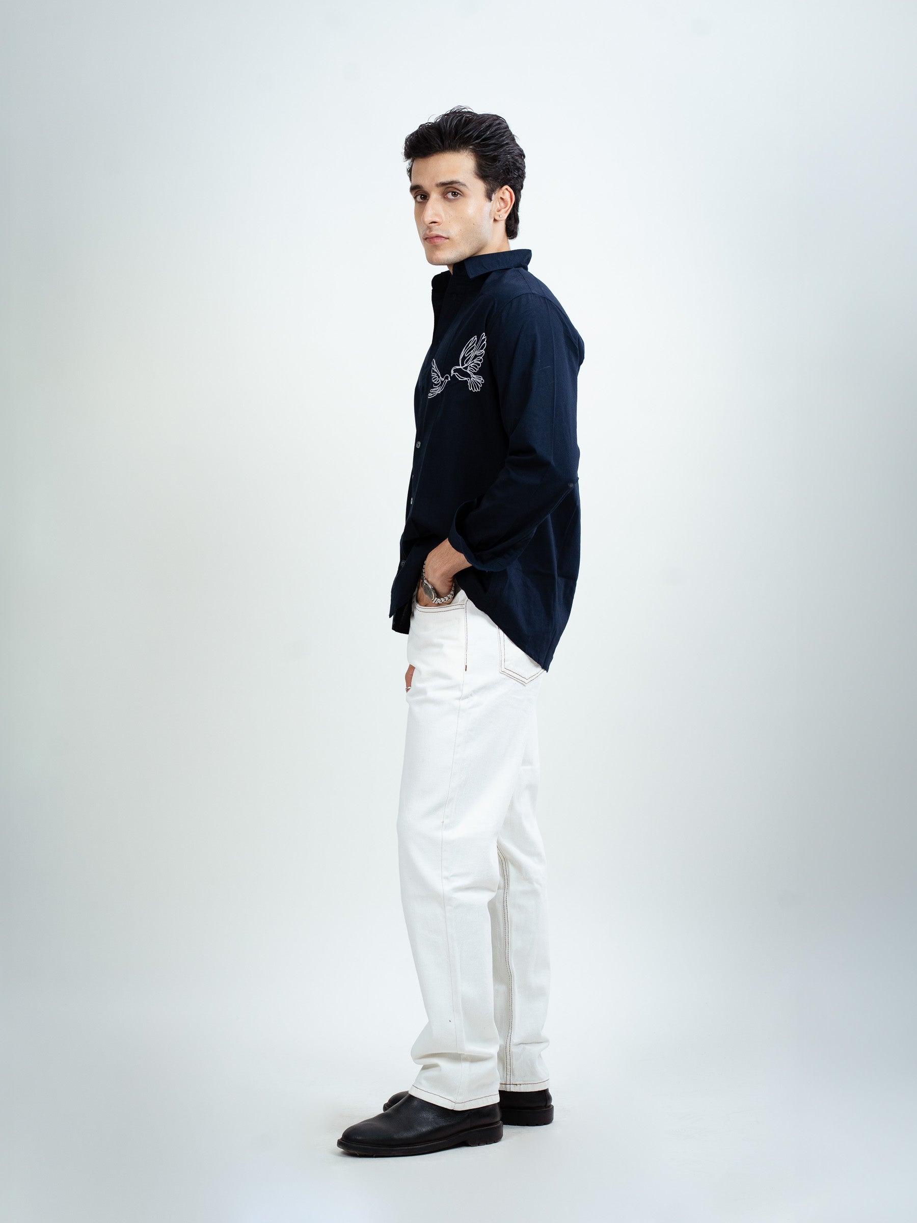 Side view of navy blue embroidered shirt showing sleeve design